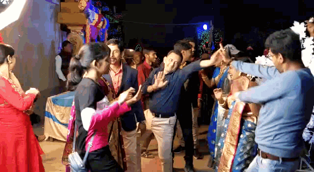 a group of people are dancing in a room
