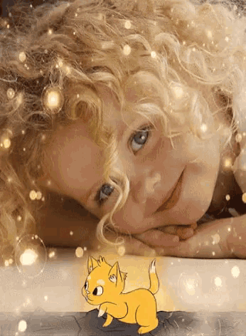 a little girl laying on a bed with a cartoon cat in the foreground