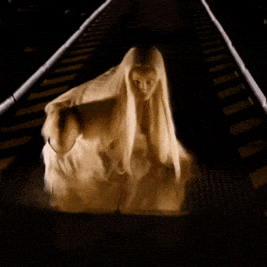 a woman with very long blonde hair is walking down a street