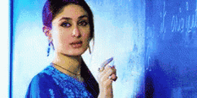 a woman in a blue dress is standing in front of a blue board and pointing at it .