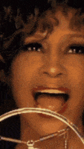 a close up of a woman 's face with her mouth wide open
