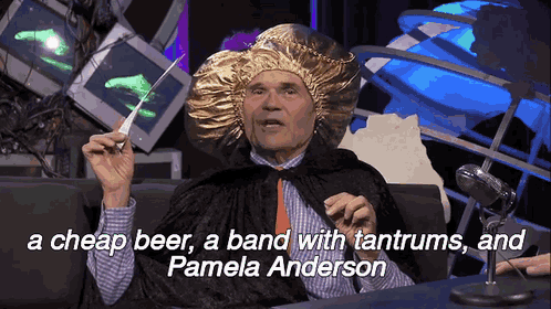 a man in a gold hat holds a baton and says pamela anderson