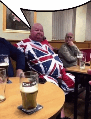 a glass of carling beer sits on a table next to a fat man