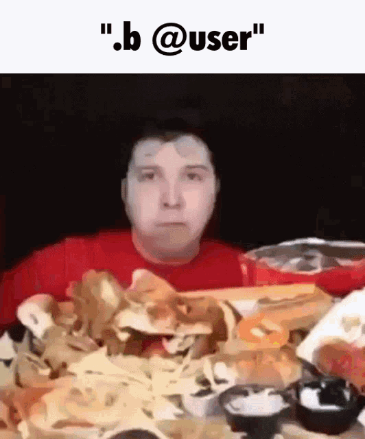 a man in a red shirt is sitting at a table with a bunch of food and the words " b @ user " above him