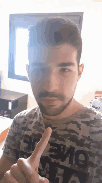 a man with a beard wearing a t-shirt that says " one " on it