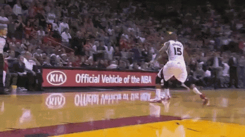 a basketball player wearing a number 15 jersey is jumping in the air