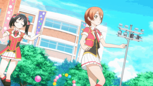 two anime girls are standing in front of a building