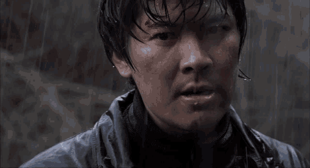 a close up of a man 's face with water coming out of his nose
