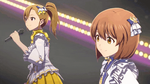 a girl singing into a microphone while another girl stands behind her