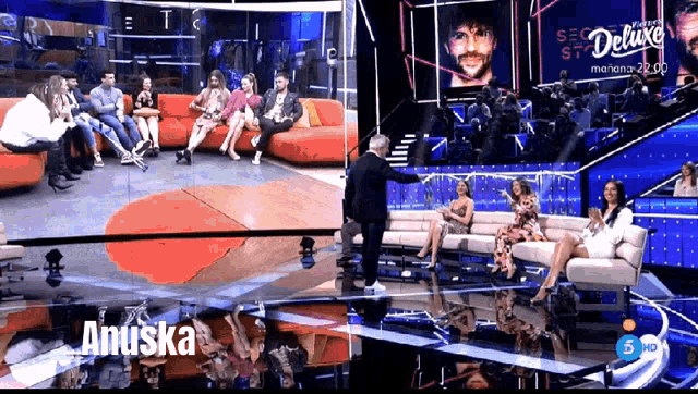 a group of people are sitting on a couch with the name anuska on the screen