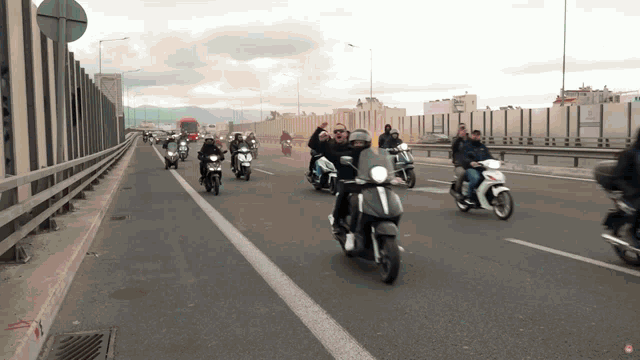 a group of people riding motorcycles on a highway