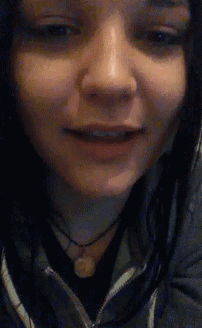 a close up of a woman 's face with her mouth open