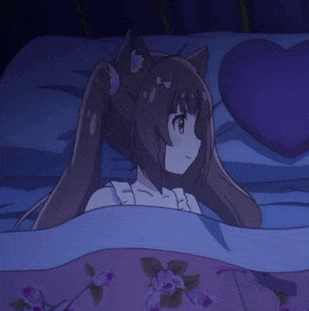 a girl in a white dress is laying on a bed holding a heart