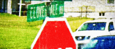 a stop sign is in front of a green sign that says tumble hills