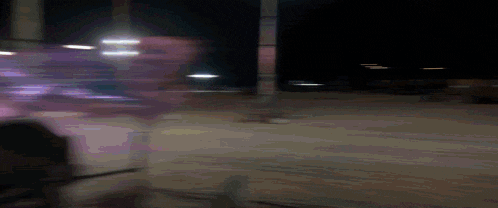 a blurry picture of a person standing in a dark room
