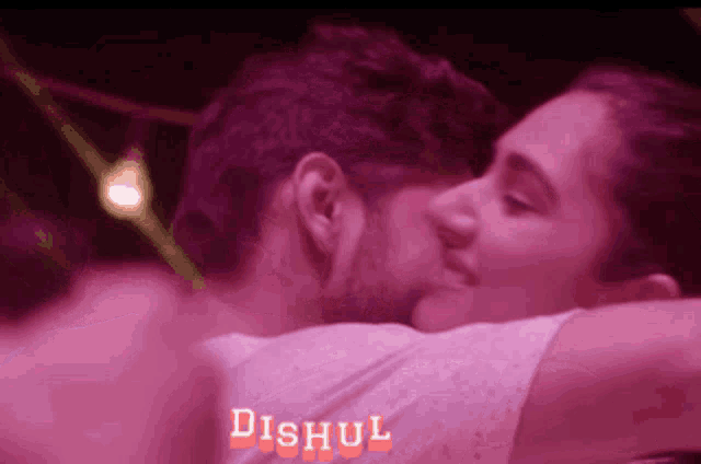 a man and a woman kissing with the word dishul in the corner