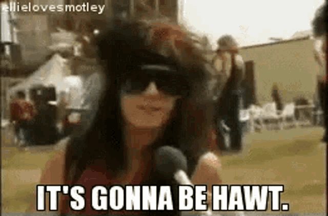 a woman is wearing sunglasses and talking into a microphone .