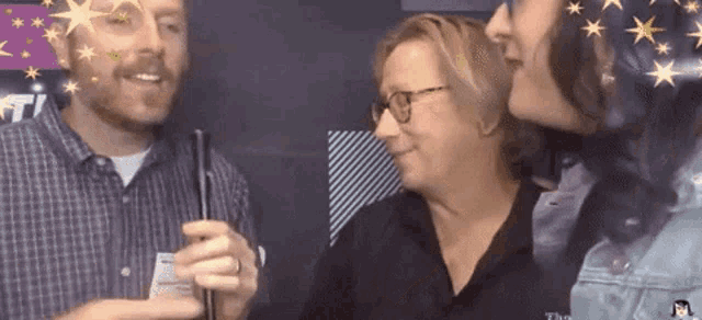 a man in a plaid shirt is talking to a woman in a black shirt
