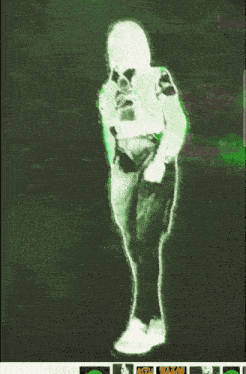 a green glowing image of a person with a gun on a green background