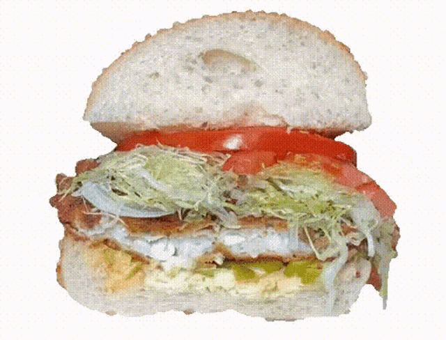 a close up of a sandwich with lettuce and tomatoes
