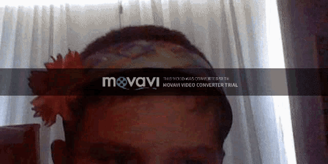 a girl wearing a headband with a flower in her hair is being displayed on a mvavi video converter trial