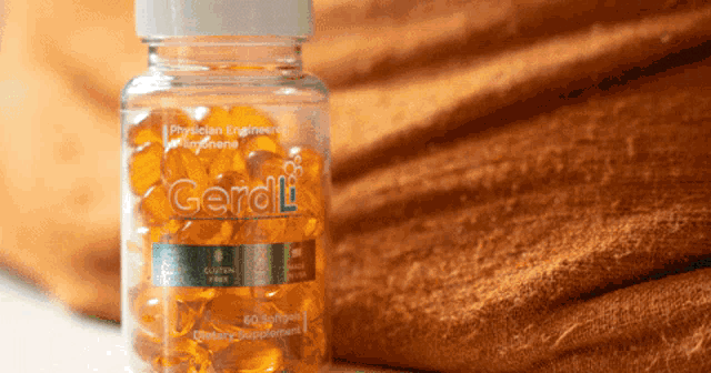 a bottle of geraldi 60 softgels sits on a table