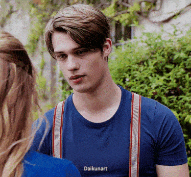 a young man wearing suspenders and a blue shirt with the word daikunart on the front