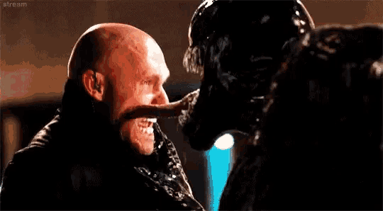a man is being attacked by a monster in a movie .