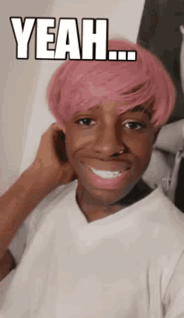 a man with pink hair has the word yeah written on his face