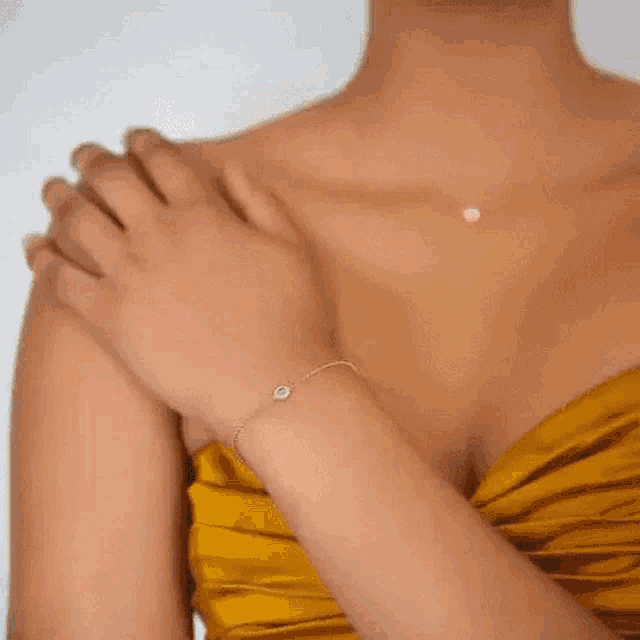 a close up of a woman 's ear with a pair of gold hoop earrings