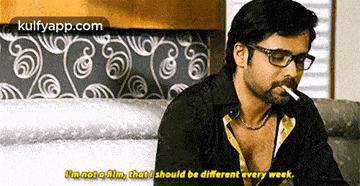 a man with glasses is smoking a cigarette and saying i 'm not a film