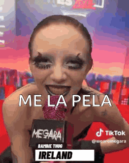 a woman with makeup on her face is holding a microphone and talking into it .