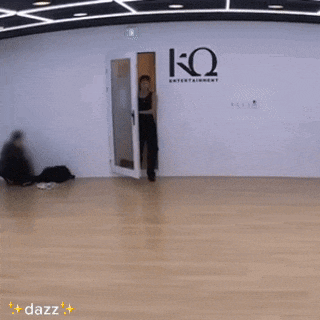a man is dancing in a dance studio with dazz written on the bottom right