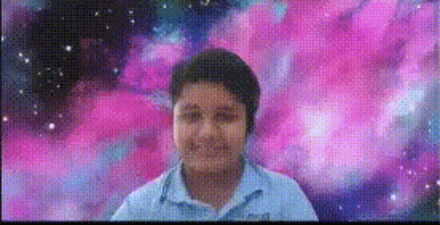 a young boy is standing in front of a galaxy background .