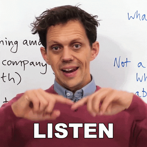 a man in front of a white board that says " listen "