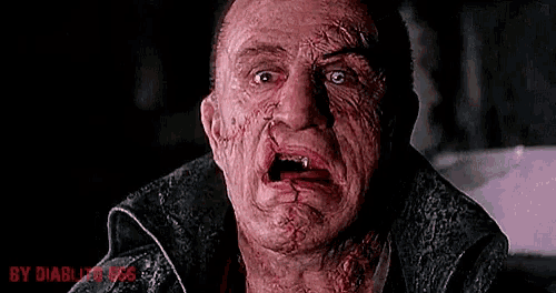 a close up of a man 's face with blood coming out of his mouth