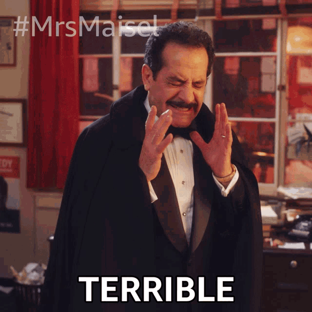 a man in a tuxedo says terrible in front of a red curtain