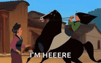 a woman is riding on the back of a black horse while a woman stands behind her .