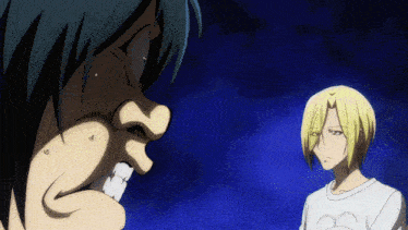 a man and a woman are standing next to each other and the man is wearing a shirt with a heart on it