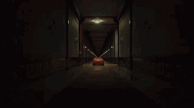 a cartoon car is driving down a hallway with its mouth open