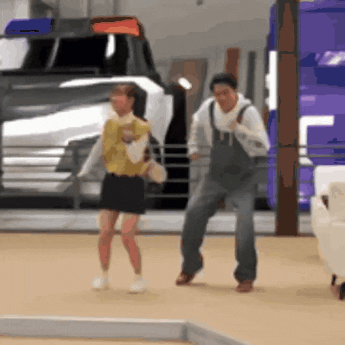 a man and a woman are dancing in a room
