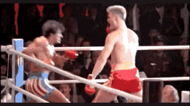 two men are boxing in a ring and one of them is wearing shorts that say america