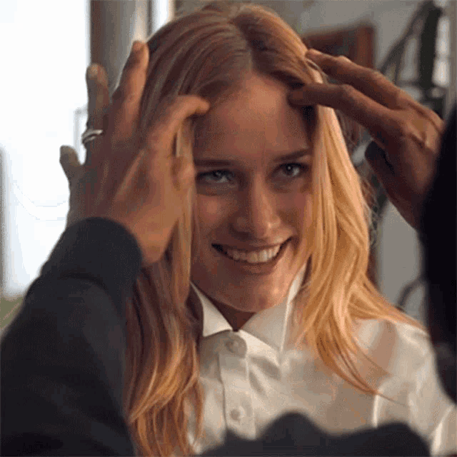 a woman in a white shirt is being touched by a man in a black shirt