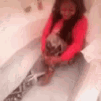 a little girl is sitting in a bathtub holding a small dog .