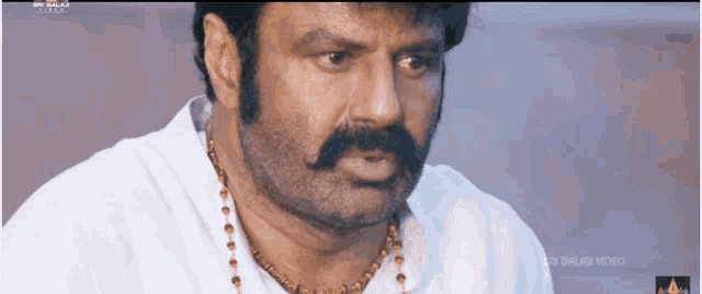 a close up of a man 's face with the words balaji video on the bottom right corner