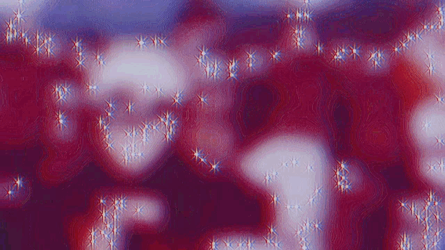 a blurry picture of a red , white and blue background with sparkles .