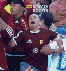a man wearing a jersey with the number 18 is crying