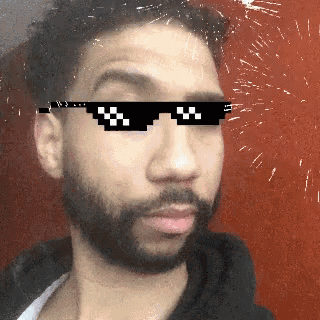 a man with a beard wearing a pair of sunglasses that say ' thug life ' on them