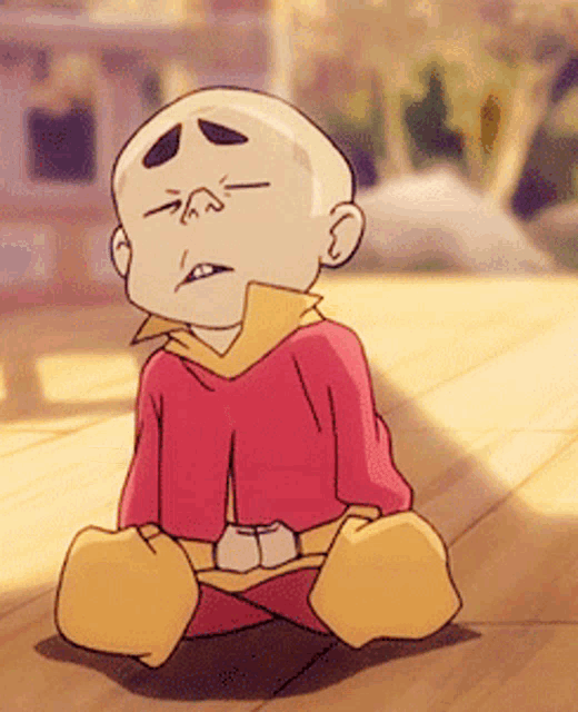 a cartoon character is sitting on the ground with his legs crossed