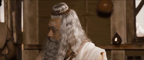 a man with a beard has a symbol on his forehead that says " shiva "